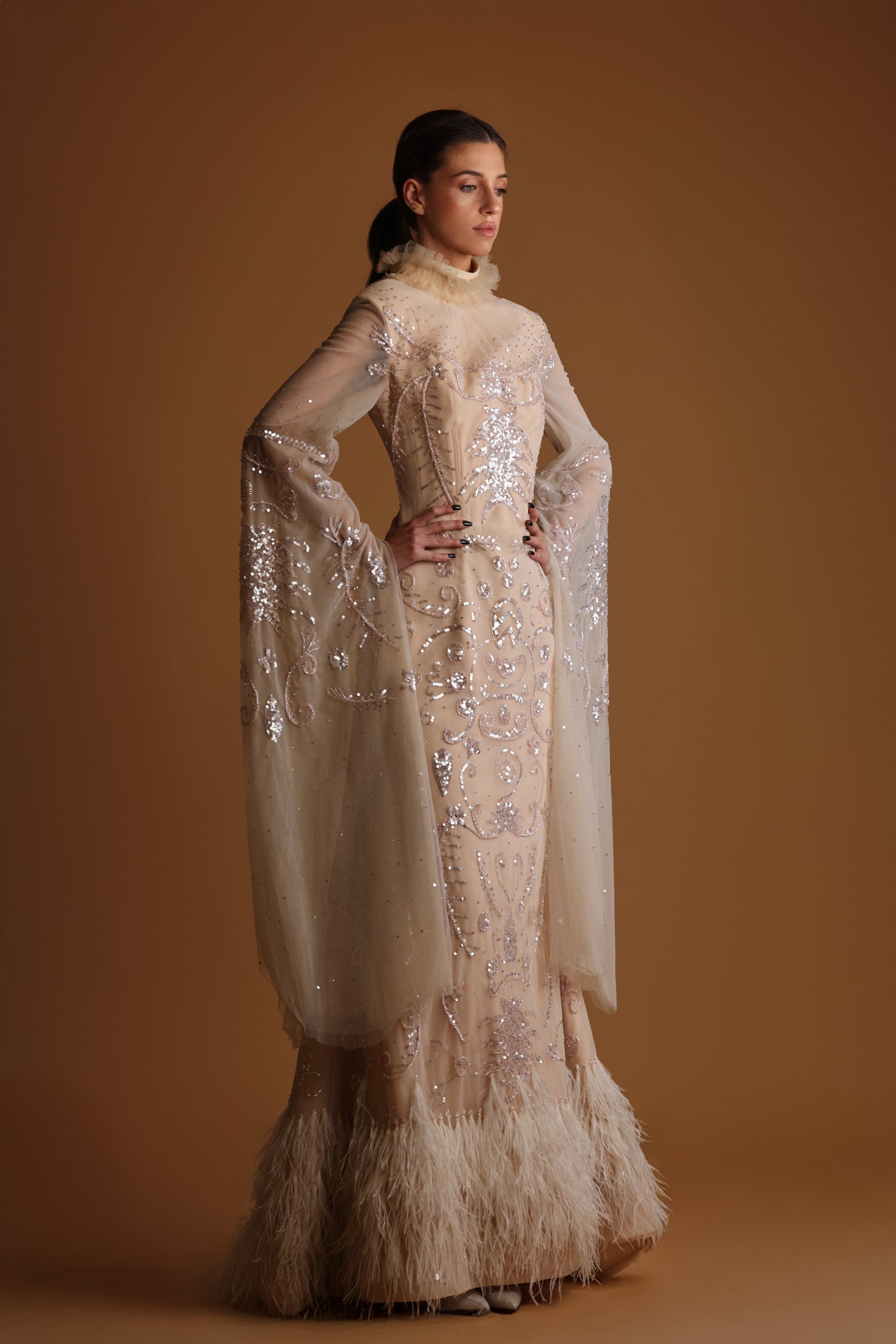 Rida Couture Nude Sequin Gown with Feather Hem